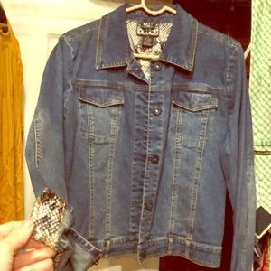 Denim jacket with snake skin pattern on sleeve